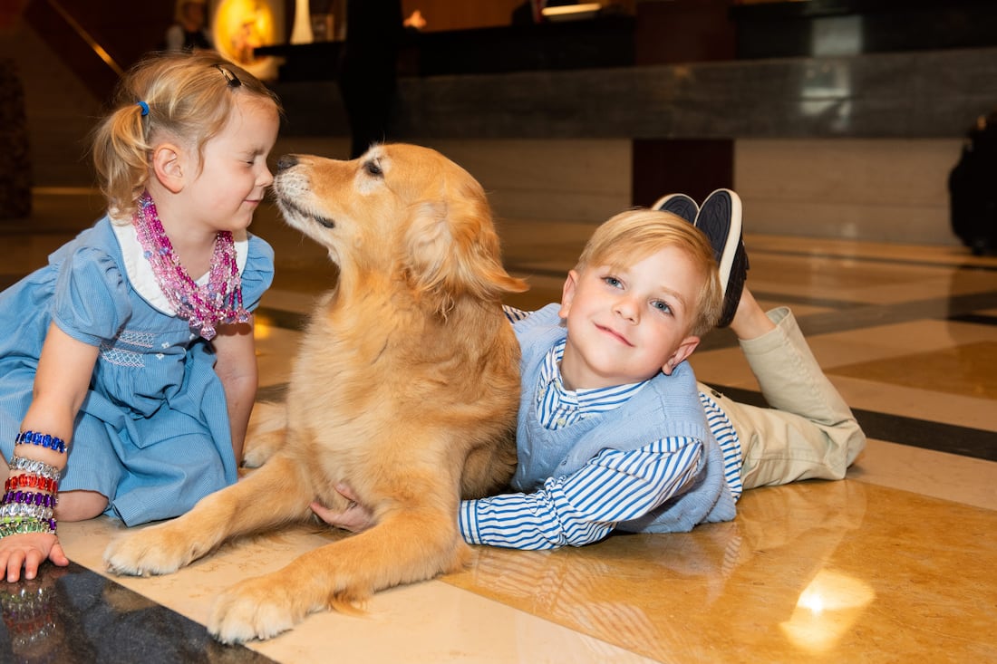 kids playing with golden retriever